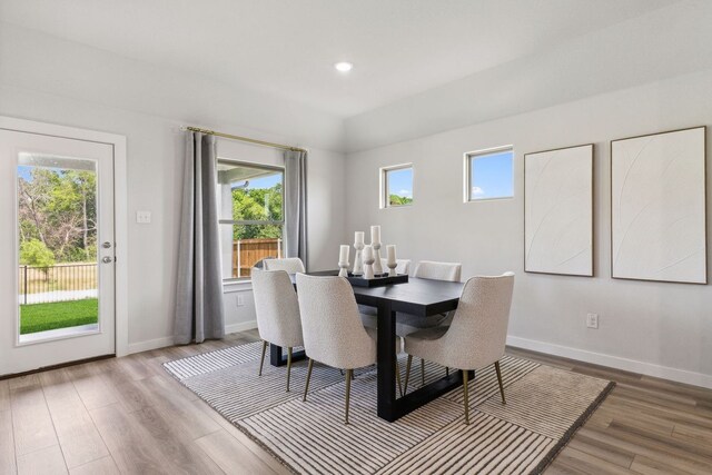 dining space with wood-type flooring