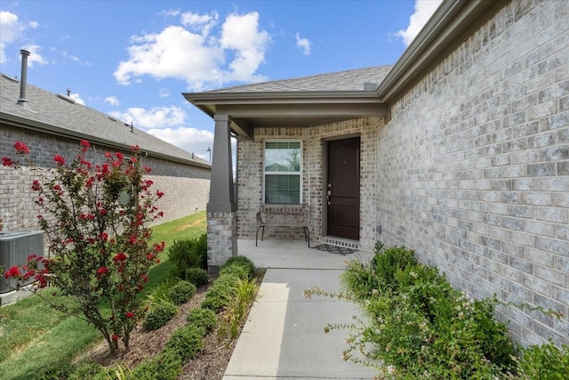 doorway to property with cooling unit and covered porch