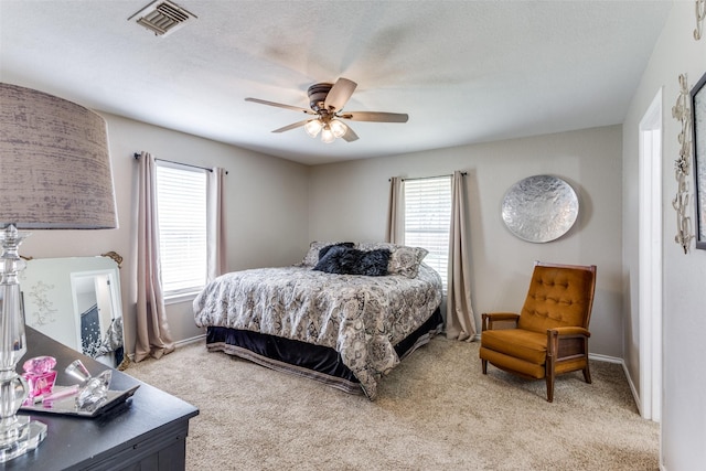 bedroom featuring carpet, ceiling fan, and a textured ceiling