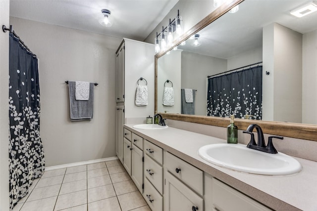 bathroom featuring tile patterned flooring, vanity, and walk in shower