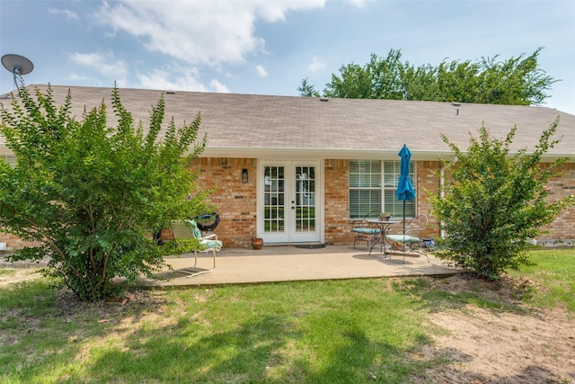 back of property featuring french doors, a patio, and a lawn