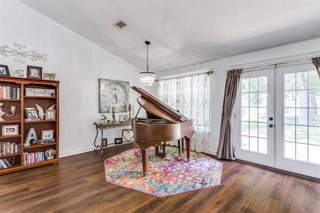 miscellaneous room featuring french doors, dark hardwood / wood-style floors, lofted ceiling, and a notable chandelier