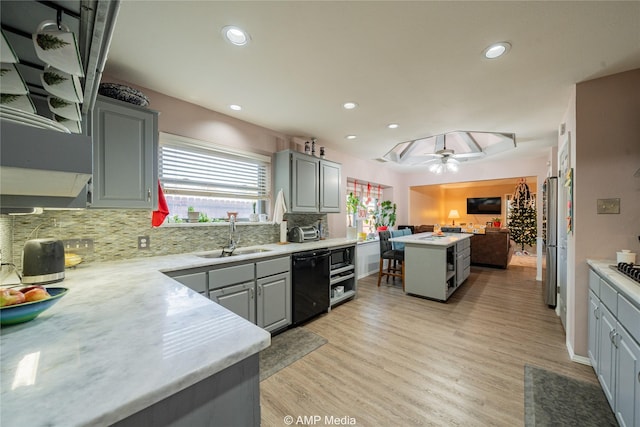 kitchen featuring sink, gray cabinets, black appliances, and a center island