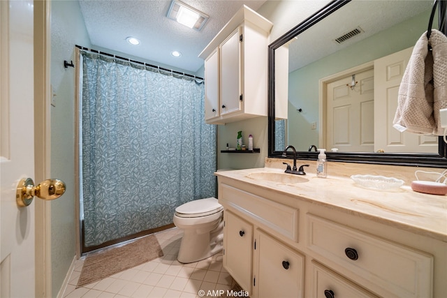 bathroom with tile patterned flooring, vanity, a textured ceiling, curtained shower, and toilet