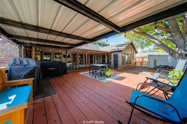 wooden deck featuring a grill