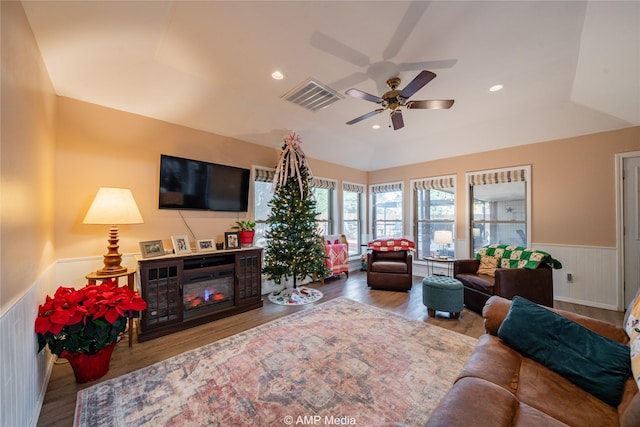 living room with a tray ceiling, hardwood / wood-style flooring, and ceiling fan