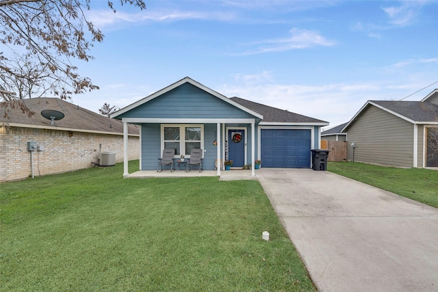 view of front of property with a porch, a garage, cooling unit, and a front lawn