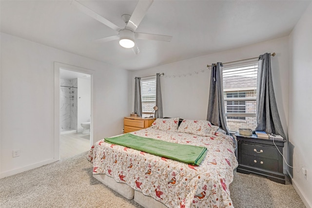 carpeted bedroom with ceiling fan and ensuite bath