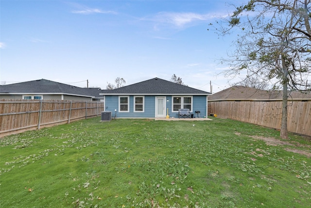 back of property with a yard and a patio