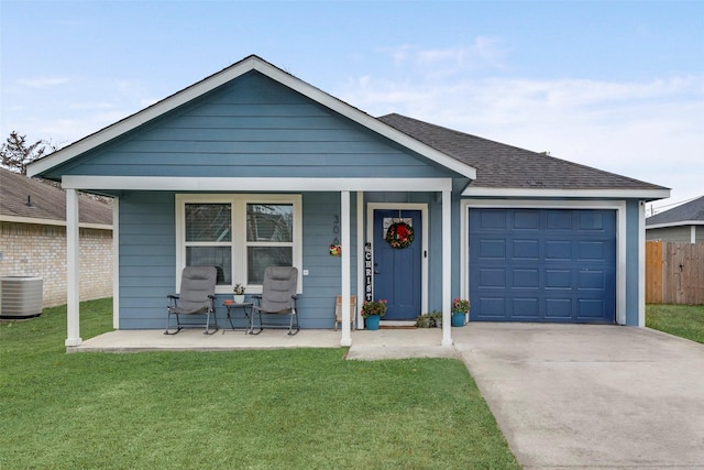 view of front facade featuring a front yard, a porch, a garage, and cooling unit