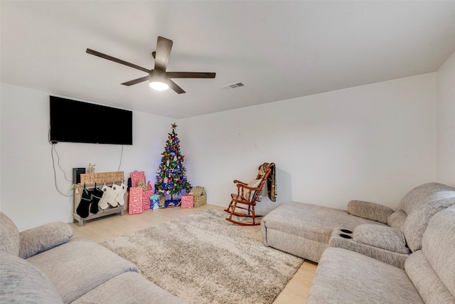 living room with hardwood / wood-style floors and ceiling fan