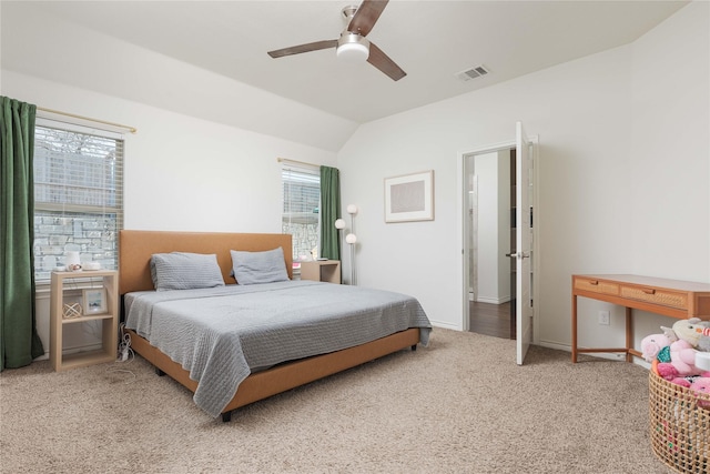 carpeted bedroom with vaulted ceiling and ceiling fan