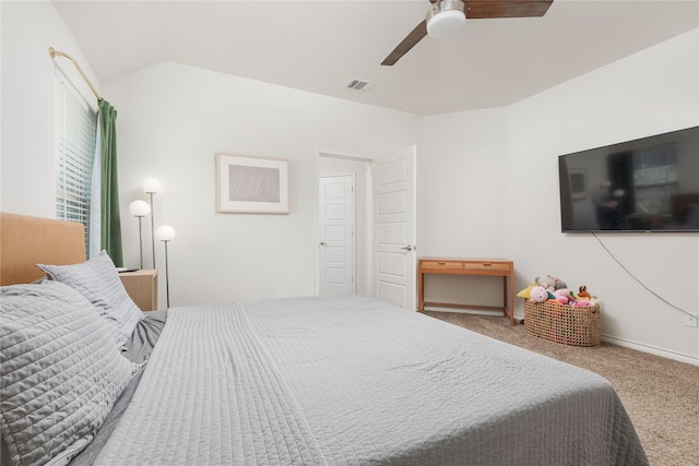 bedroom with ceiling fan, vaulted ceiling, and carpet floors