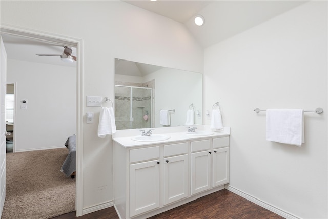 bathroom with hardwood / wood-style floors, lofted ceiling, ceiling fan, a shower with shower door, and vanity