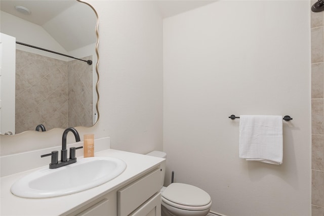 bathroom featuring vaulted ceiling, vanity, and toilet