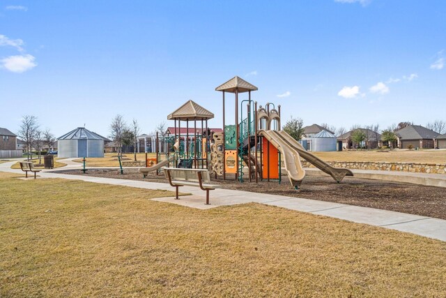 view of jungle gym featuring a lawn