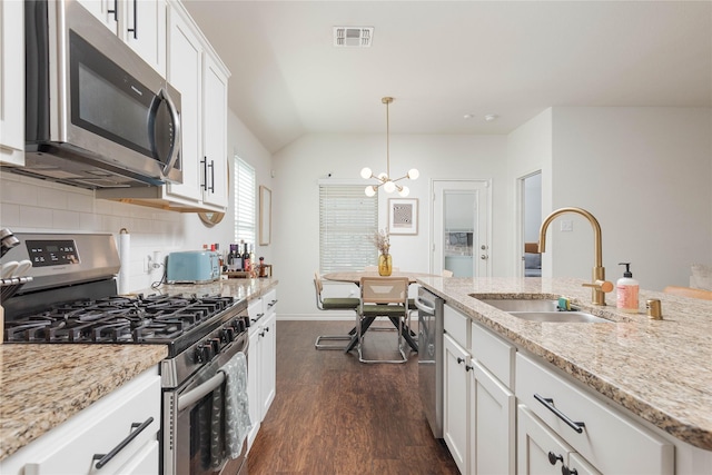 kitchen with stainless steel appliances, decorative light fixtures, white cabinets, and sink