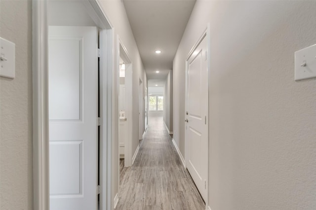 hall with light hardwood / wood-style flooring