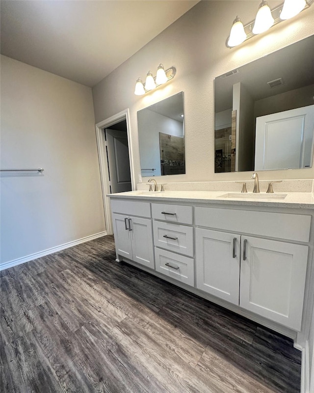 bathroom with a shower, hardwood / wood-style floors, and vanity