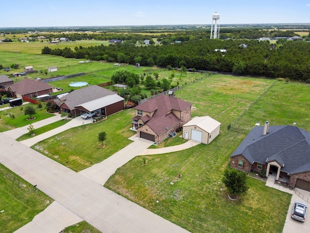 view of front of house with a front yard, concrete driveway, brick siding, and fence