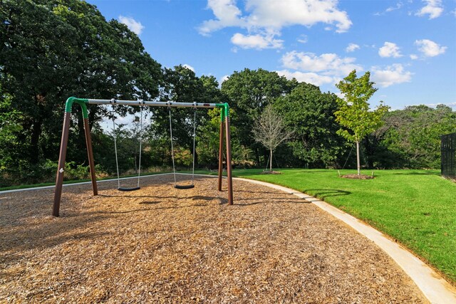 view of playground with a lawn