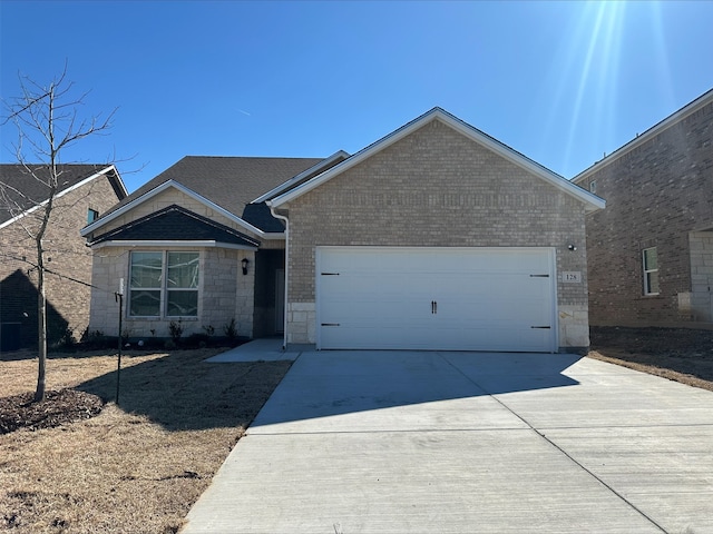 ranch-style home featuring stone siding, concrete driveway, brick siding, and an attached garage