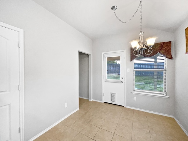 tiled spare room with lofted ceiling and a chandelier