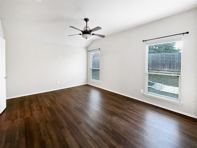 spare room with vaulted ceiling, dark hardwood / wood-style floors, and ceiling fan