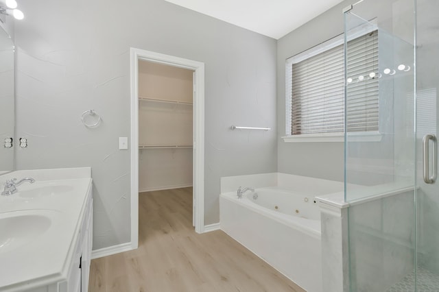 bathroom with vanity, wood-type flooring, and shower with separate bathtub