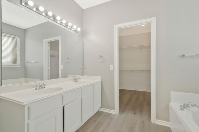 bathroom featuring vanity, a tub, and hardwood / wood-style floors