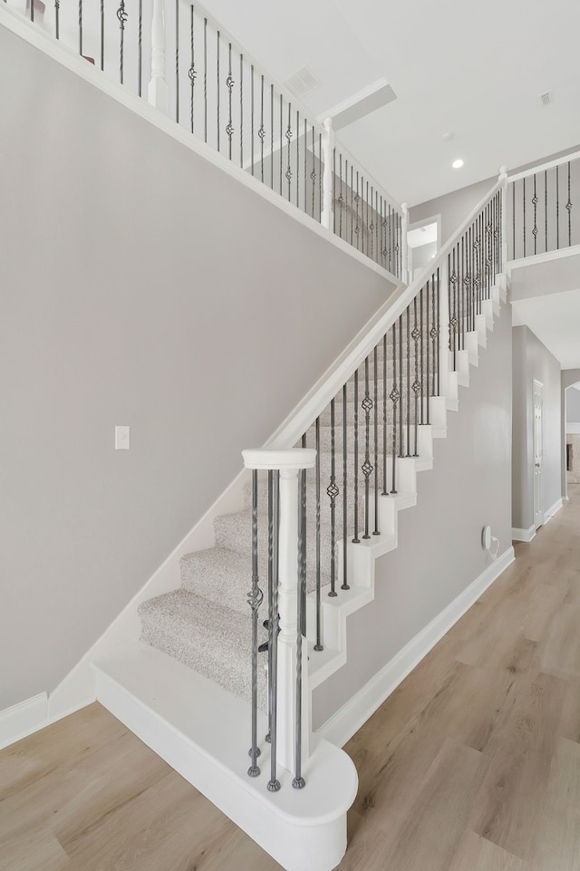 stairway with hardwood / wood-style flooring