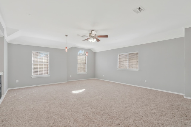 carpeted spare room with vaulted ceiling and ceiling fan