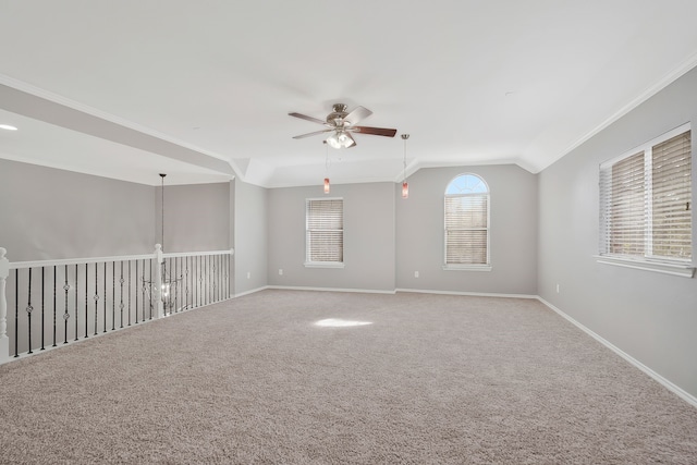 unfurnished room with vaulted ceiling, ceiling fan, crown molding, and carpet floors