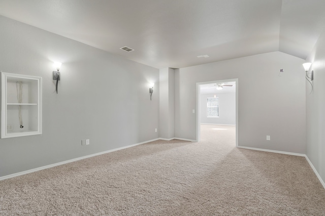 empty room featuring lofted ceiling and carpet floors