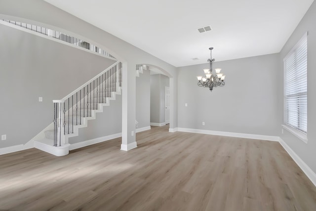 interior space featuring a notable chandelier and light hardwood / wood-style flooring