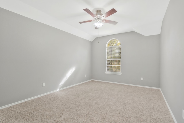 unfurnished room with vaulted ceiling, ceiling fan, and carpet