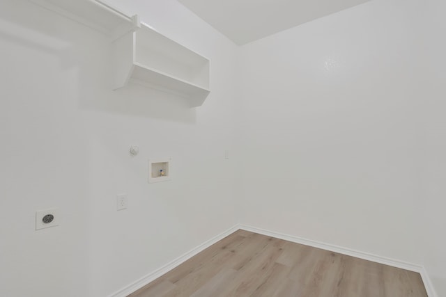 washroom with electric dryer hookup, hookup for a washing machine, gas dryer hookup, and light wood-type flooring