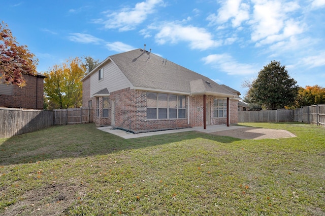 back of property featuring a yard and a patio