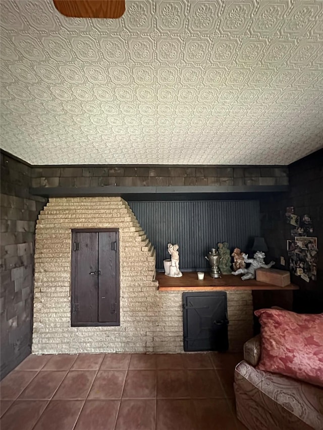 bar featuring an ornate ceiling and tile patterned floors