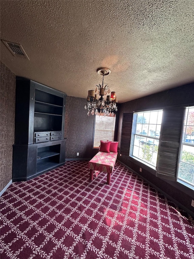 unfurnished room featuring a chandelier, carpet, visible vents, and baseboards