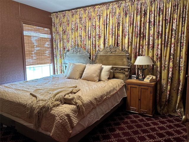 bedroom featuring dark colored carpet