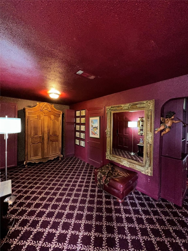 cinema featuring carpet and a textured ceiling