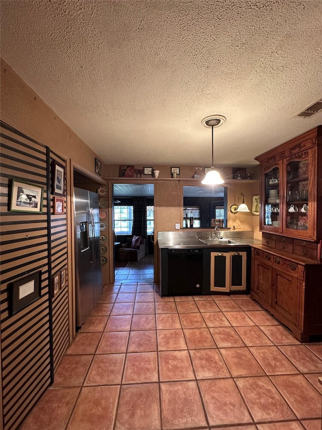 1828 Shepheard St, Fort Worth, TX 76114 - kitchen with stainless steel fridge, black dishwasher, a textured ceiling, a peninsula, and glass insert cabinets