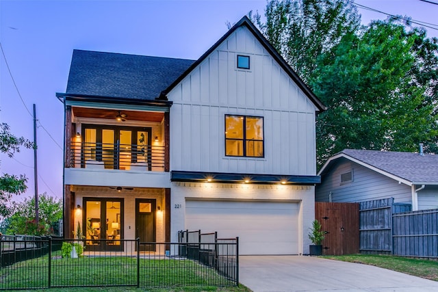 view of front of home featuring a yard, a balcony, a garage, and ceiling fan