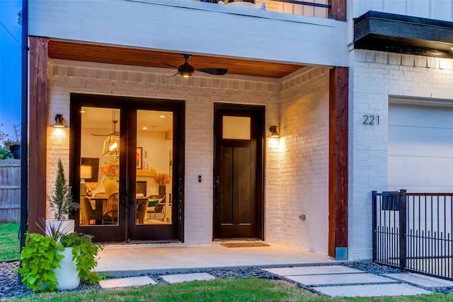 doorway to property featuring ceiling fan and a garage