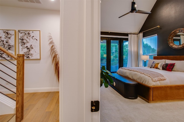 bedroom with ceiling fan, light hardwood / wood-style floors, and lofted ceiling