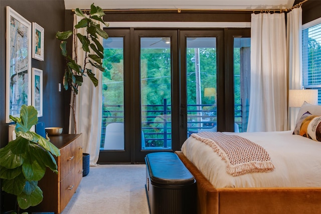 bedroom featuring light colored carpet, access to outside, and french doors