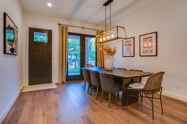 dining space featuring wood-type flooring and french doors