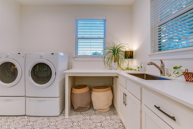 washroom with cabinets, independent washer and dryer, light tile patterned flooring, and sink