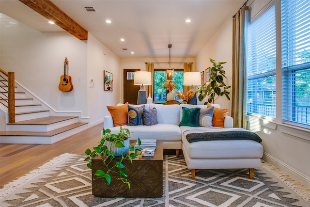 living room featuring hardwood / wood-style floors and beam ceiling